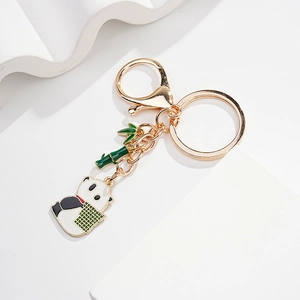 Close-up of cute panda keychain with green bamboo charm and gold lobster clasp
