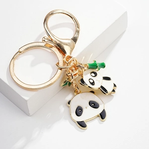 Detail of panda metal keychain featuring black and white enamel finish with bamboo charm