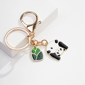 Detail of cute enamel panda keychain with bamboo shoot charm on gold lobster clasp