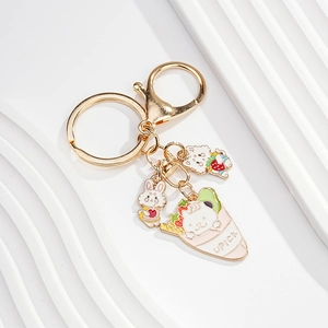 Detail of cute enamel rabbit and cat charms with gold-plated keychain hardware