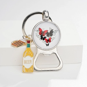 Detail of vintage butterfly keychain with beer bottle charms and integrated opener function