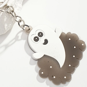 Close-up of cute cartoon ghost keychain with semi-transparent base and silver ring
