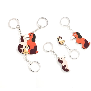Three-piece wooden puppy puzzle keychain set featuring creative spotted dog family designs