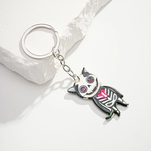 Detailed macro view of a black skeleton cat keychain with pink accents for Halloween
