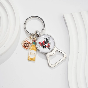 Detail of silver beer bottle opener keychain with butterfly glass gem and enamel beer charms