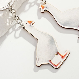 Realistic white duck wooden keychain charm with high-definition printing on a white background