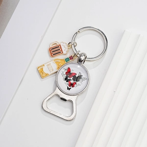 Detail view of silver alloy bottle opener keychain with butterfly and beer mug pendants