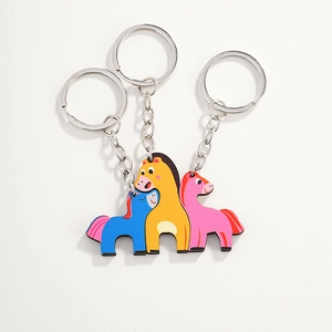 Three-piece set of colorful cartoon pony wood-style keychains in blue, yellow, and pink