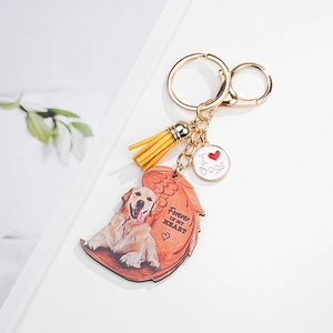 Golden pet memorial keychain featuring a Golden Retriever on wing pendant and yellow tassel