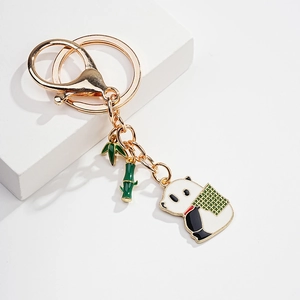 Detail of cute panda enamel keychain with bamboo charms and gold lobster clasp