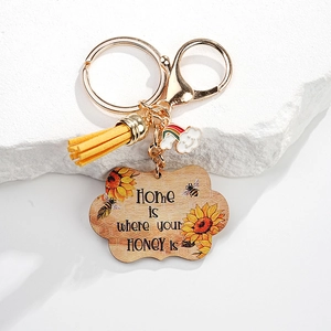 Detail of sunflower keychain with Home is where your HONEY is quote and yellow tassel
