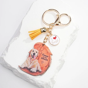 Golden Retriever memorial acrylic keychain with angel wings and a yellow tassel pendant