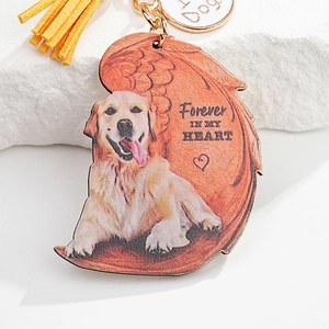 Detail of dog memorial keychain with angel wings design and yellow leather tassel