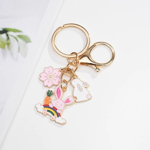 Cute pink bunny keychain with cherry blossom and rainbow charms in golden finish