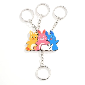 Set of four colorful cartoon wooden rabbit keychains in yellow, pink, blue and white colors