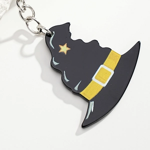 Detailed close-up of a black acrylic wizard hat keychain with yellow stars for Halloween gift