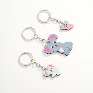 Detailed view of three cute cartoon koala wooden keychains in grey, pink and white
