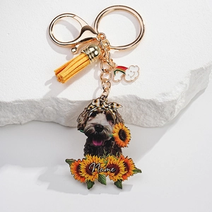 Detail view of custom dog keychain with sunflower acrylic charm and yellow leather tassel