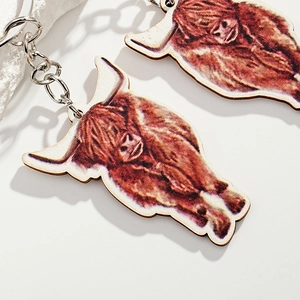 Creative Highland Cow wooden keychain with realistic brown fur print and metal ring