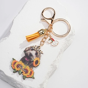 Detail of personalized dog sunflower keychain with yellow tassel and gold hardware