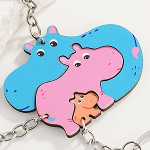Three-piece nesting cartoon hippo wooden keychains in blue, pink, and orange tones