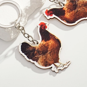 Artistic wooden rooster keychain with realistic brown hen print on a white background