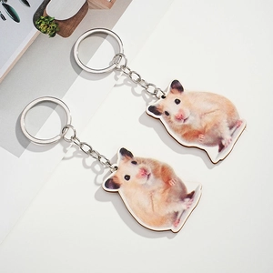 Detail showing two cute hamster wooden charms on metal keychains for bags or keys