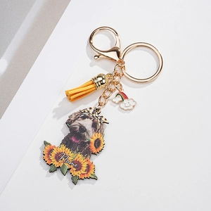 Detail of custom sunflower dog keychain with yellow tassel and gold lobster clasp