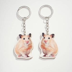 Detail view of cute wooden hamster keychains with printed realistic animal graphics