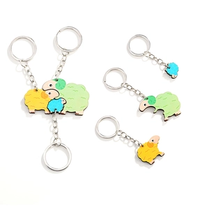 Three colorful wooden sheep puzzle keychains in green yellow and blue for family gift