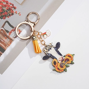Detailed view of sunflower cow acrylic keychain with yellow tassel and customized name option