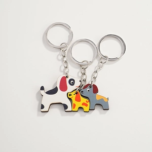 Three cute cartoon Dalmatian dog wooden keychains in white, yellow and grey colors