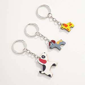 Detailed macro view of three cute dalmatian puppy wooden keychains with layered edges