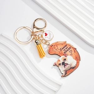Detail of English Bulldog acrylic keychain with yellow suede tassel and gold metal clasp
