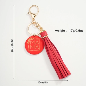Red tassel keychain with MAMA circular tag and leopard print detail on white background