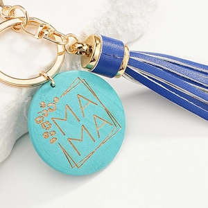 Blue leather tassel keychain with wooden Mama leopard print charm on a stone base