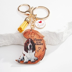 Detailed close-up of a dog-themed keychain with moon-shaped pendant and yellow tassel