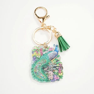 Exquisite painted peacock and flower acrylic keychain with a green tassel and gold clasp