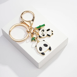 Detail of panda enamel keychains with golden alloy rings and green bamboo pendants