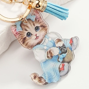 Cute acrylic cat keychain with blue floral dress, light blue tassel and golden clasp