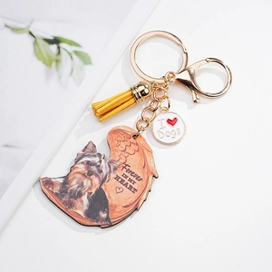 Detail of angel wing acrylic dog keychain with yellow tassel and pet memorial engraving