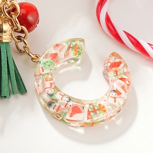 Christmas letter C resin keychain with snowman miniatures and red bell on white background