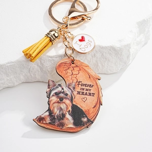 Close-up of Yorkshire Terrier acrylic keychain with golden clasp and leather tassel