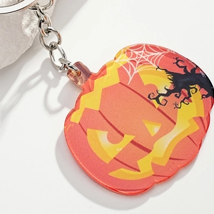 Creative Halloween pumpkin acrylic keychain with spooky tree and spider web pattern