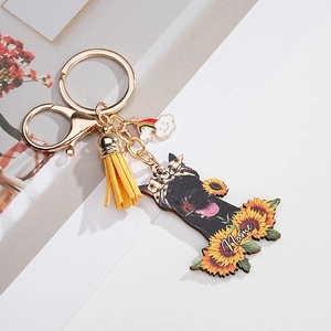 Detail of sunflower dog keychain featuring custom name plate and yellow leather tassel