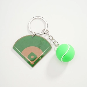 Close-up of baseball field acrylic pendant and green ball charm on a silver keychain
