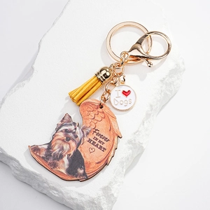 Cute Yorkshire Terrier keychain with angel wings and yellow tassel for pet lovers