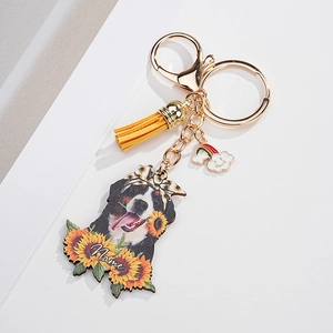 Detailed view of Berner Mountain Dog keychain with sunflower, yellow tassel, and gold clasp