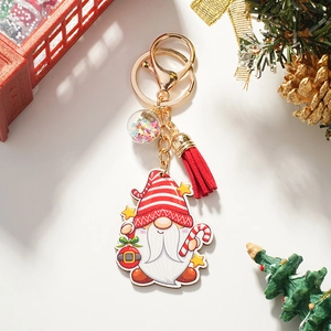 Porte-clés nain de Noël détaillé avec pompon rouge et boule à paillettes sur fond festif
