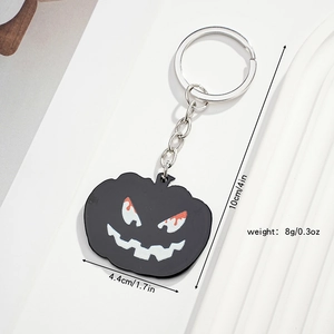 Detail of black Halloween pumpkin keychain with size markings and weight specifications